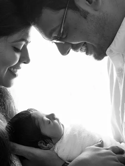 A black and white version of the tender family and newborn portrait. Monochrome enhances the emotion and timelessness of this precious moment.