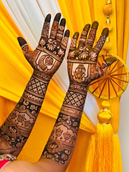 A full view of the wedding mehendi, with intricate patterns and personalized elements on both hands.
