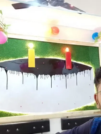 This fun wall art piece was designed for a bakery. It's a cake-shaped mirror with a chocolate-drip effect made from resin, set against a green, grassy background.