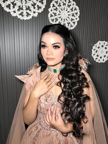 A serene portrait of the client, her makeup and jewelry in perfect harmony.