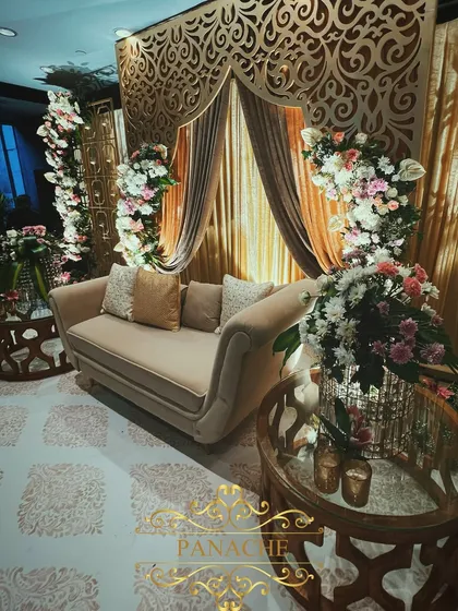 A side angle of the elegant Roka stage, highlighting the plush seating and detailed floral arrangements. The design provides a beautiful setting for the couple's first official ceremony.