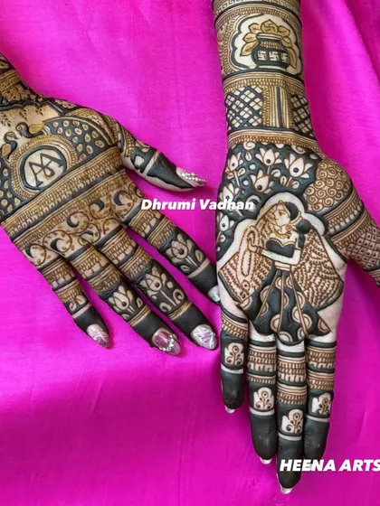 A close-up of a personalized bridal mehendi, featuring a couple figure and initials integrated into the traditional design.