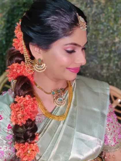 A side view showing her beautiful floral braid. Fresh flowers in the hair are a perfect accessory for a baby shower.