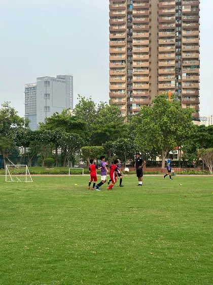 A coach observing a small-sided game, a crucial part of our training methodology to simulate real match pressure.