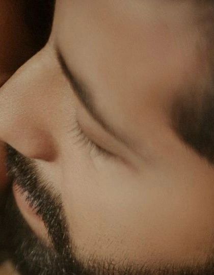 A macro shot capturing the intimate detail of a gentle touch. It's these small, often unnoticed gestures that tell the biggest stories about a couple's connection.