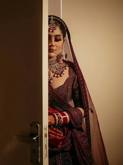 A creative bridal portrait, with the bride peeking from behind a door. This shot creates a sense of anticipation and mystery, adding an artistic touch to the bridal gallery.