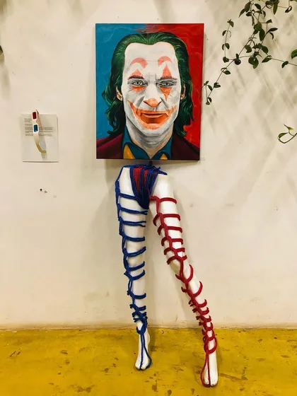 A closer look at my 'Hidden in Plain Sight' installation. The piece explores the idea of filters and perception. Without the red lens, you see the Joker's familiar face, but looking through it reveals the man underneath, a commentary on mental health and the masks we wear.