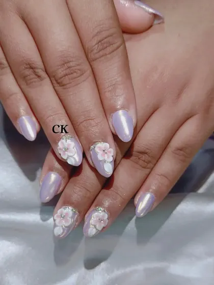 This set features a pearlescent lavender chrome base with beautifully sculpted 3D pink and white flowers.