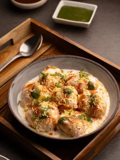 A closer crop of our Dahi Vada shot, focusing on the textures of the yogurt, chutneys, and sev.