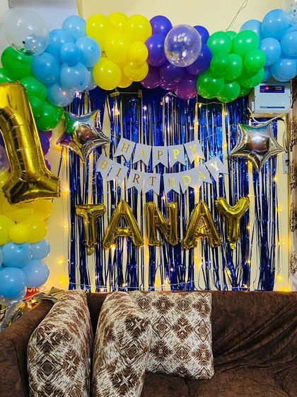 The birthday backdrop for Tanay, with the 'Happy Birthday' banner and name balloons clearly visible.