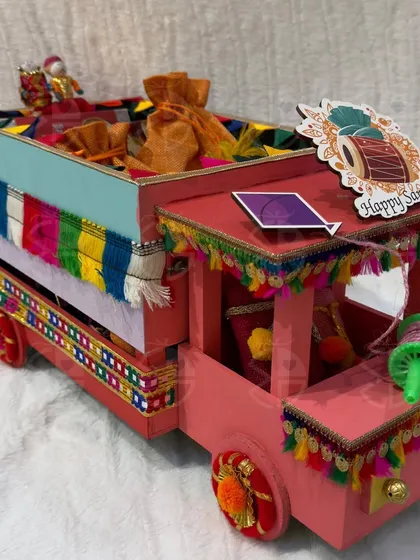 A festive Lohri hamper designed in the shape of a colorful truck. This creative packaging is filled with traditional treats and is sure to be a conversation starter.