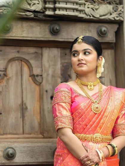 This bride is ready for her wedding ceremony. I created a classic look with a neat updo, traditional jewelry, and flawless HD makeup that enhances her natural beauty.