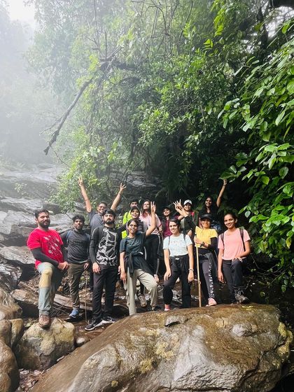 A group of trekkers taking a break at a stream crossing on the Netravathi trail.