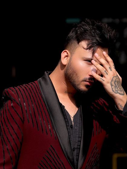 Another shot of the maroon and black sequin tuxedo, highlighting its modern design and edgy vibe.