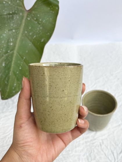 Holding a Green Celadon tumbler. It's the perfect size for a glass of water, juice, or lassi.