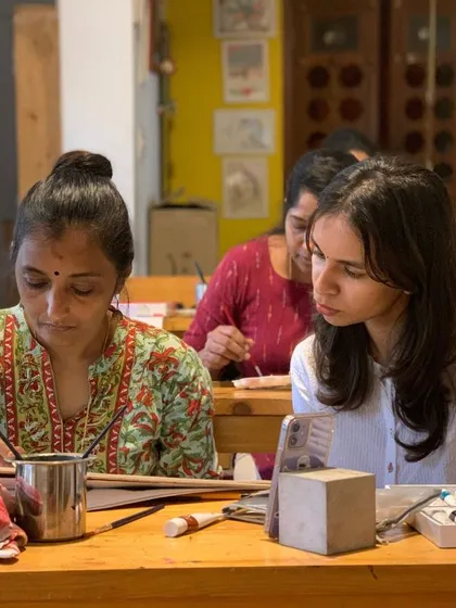 Two students collaborate and learn from each other, embodying the community spirit of our studio.