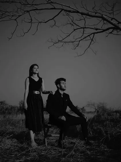 A quiet, contemplative pose under the tree. The black and white treatment adds to the serene and almost meditative mood of the moment.