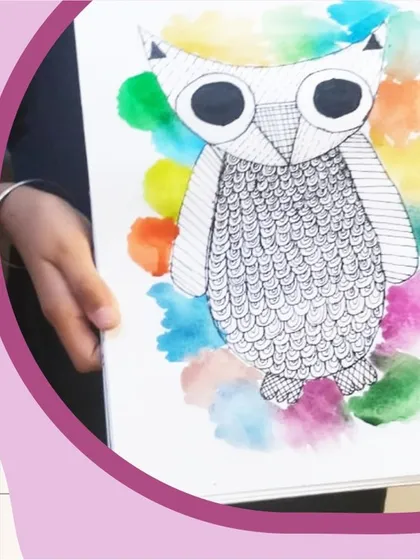 Combining zentangle and watercolor! This student created beautiful, structured patterns on the owl with a pen and then added a splash of color with a watercolor wash in the background.