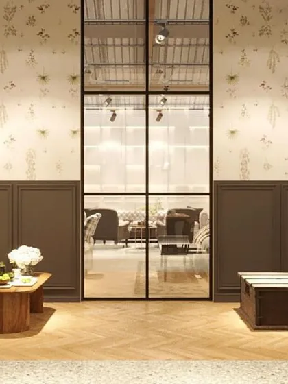 This rendering shows a formal waiting area or living room setup. The design uses classic furniture silhouettes, elegant wallpaper, and paneled walls to create a sophisticated and timeless atmosphere.