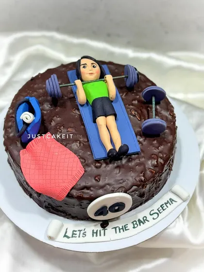 A "Fit at Forty" cake for a fitness enthusiast. This dark chocolate cake is topped with an edible figurine lifting weights at the gym.