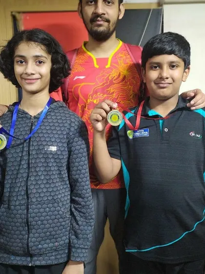 Our coach with medalists Vaidehi Chogle and Ansh Karnavar at the Rotary District Table Tennis Tournament.