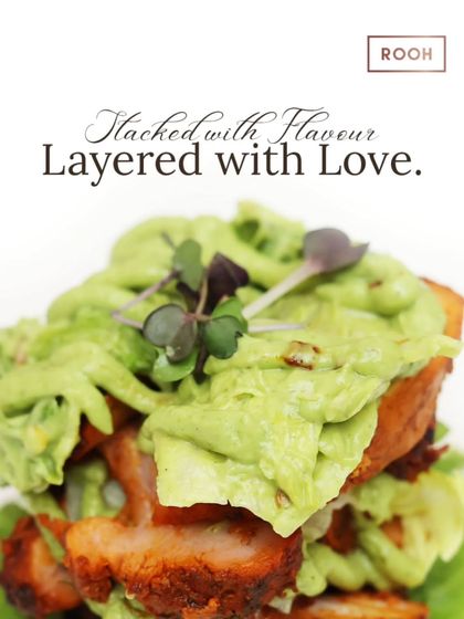 This dish is stacked with flavour and layered with love. It's a hearty and satisfying creation, with tender morsels of meat and a generous topping of creamy green sauce.