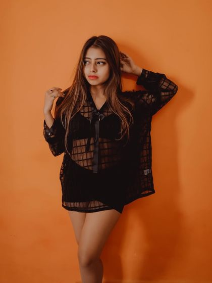 This shot captures a classic fashion pose against a vibrant, solid-colored wall, creating a clean and modern look.