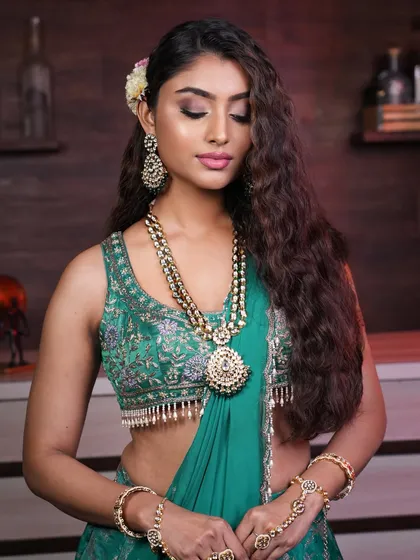 This style is perfect for someone who wants to showcase long, voluminous hair with a modern, beachy-wave texture for a Sangeet or cocktail party.