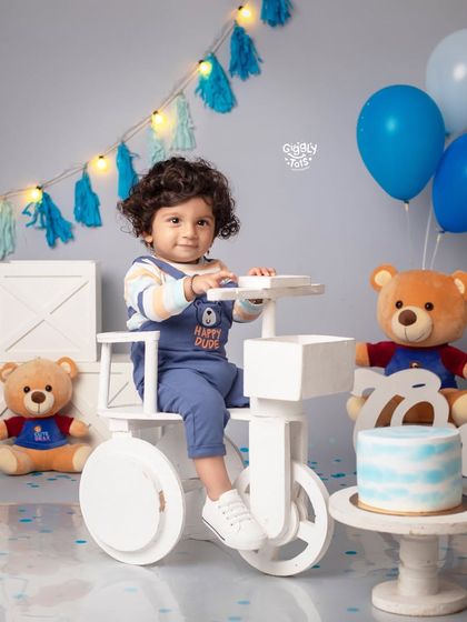 Turning one is a big adventure! This little dude is ready to ride his tricycle into his second year.