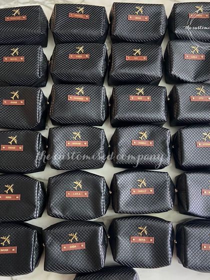 For a sleek and masculine look, these travel pouches feature a black carbon-fiber texture. Each pouch is personalized with a name on a leather tag, making it a sophisticated travel accessory for him.