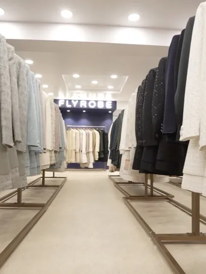 Looking down the aisle of our store, you can see the sheer volume and variety of outfits we have available for rent.