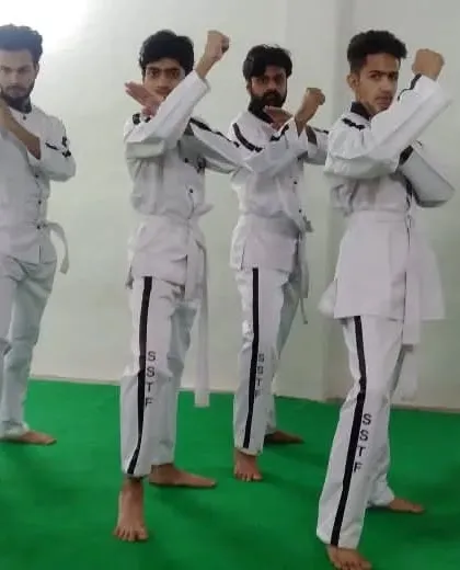 A line of my senior students in uniform, demonstrating a synchronized blocking form. This shows the unity and discipline of our team.