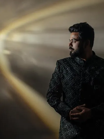 A creative double exposure portrait. We blended the groom's pensive look with the bride's serene profile to create a single, artistic image that speaks of their connection.