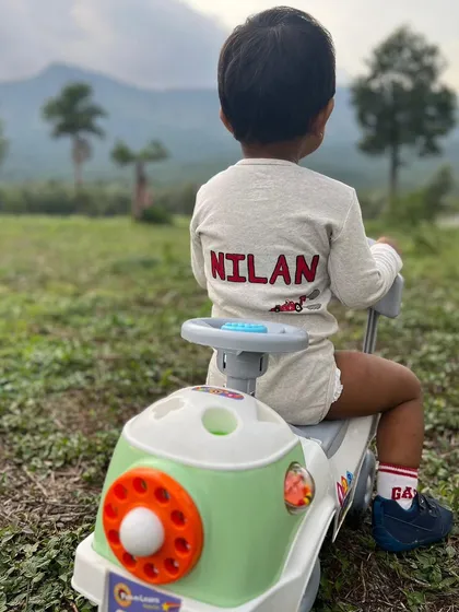 I also offer custom fabric painting to make special occasions even more memorable. This personalized romper was designed for a baby's birthday photoshoot, featuring his name hand-painted on the back.
