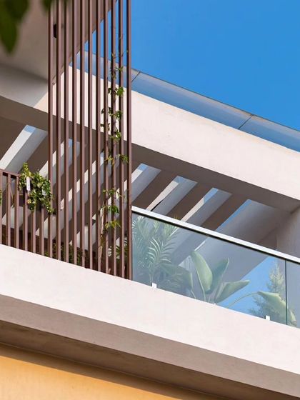 A detail of the upper balcony and pergola structure at the Sarjapur home, showcasing the clean, modern lines.