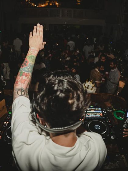 Greeting the crowd from the DJ booth at a "blur hour" event. I make sure to connect with the audience, whether it's a crowd of thousands or an intimate club.