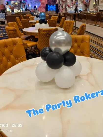 Simple but elegant table centerpieces in black, white, and silver to match the Boss Baby theme.
