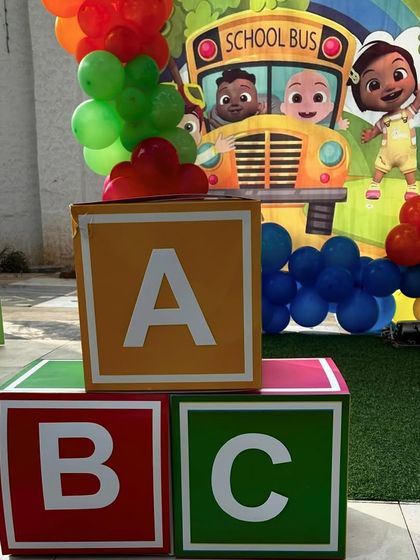 Large, colorful ABC blocks used as props for a Cocomelon-themed party. These are great for adding a playful and educational touch to the decor.