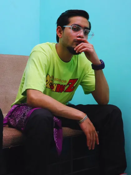 A candid shot from a photoshoot, in a moment of thought. My journey is driven by the desire to reach my goals in the music industry.