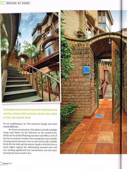 The entrance to a home should be a transition from the outside world into a personal sanctuary. Here, the pathway is framed by walls of Delhi quartzite stone and an arched brick gateway, materials sourced locally for their durability and character. The design invites a connection with the natural elements from the very first step.