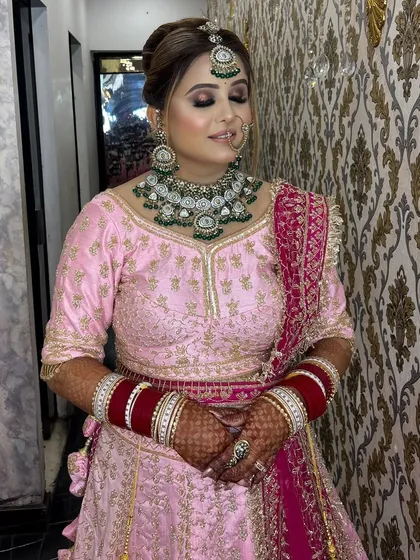 The final look for our bride in a soft pink lehenga. The makeup is perfectly balanced with a strong eye, rosy cheeks, and a neutral lip, creating an elegant and polished finish.