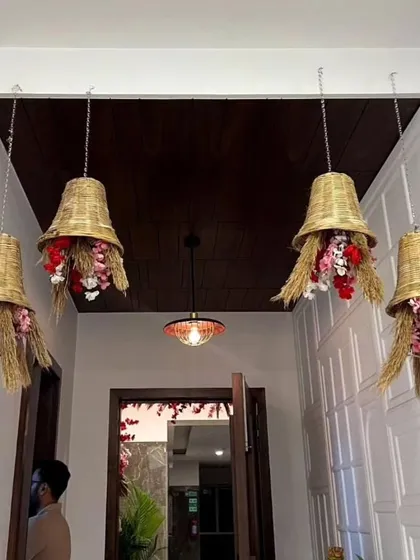 Unique hanging decorations for a housewarming, made from woven baskets and filled with flowers, adding a rustic and traditional touch.