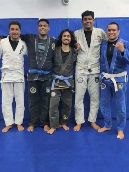 A group of training partners after a session focused on control and submission techniques. This is where the science of Jiu-Jitsu comes to life.