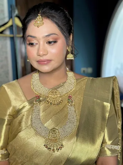A close-up of the Haldi makeup. The look is subtle and elegant, with a focus on radiant skin and a soft, neutral color palette.