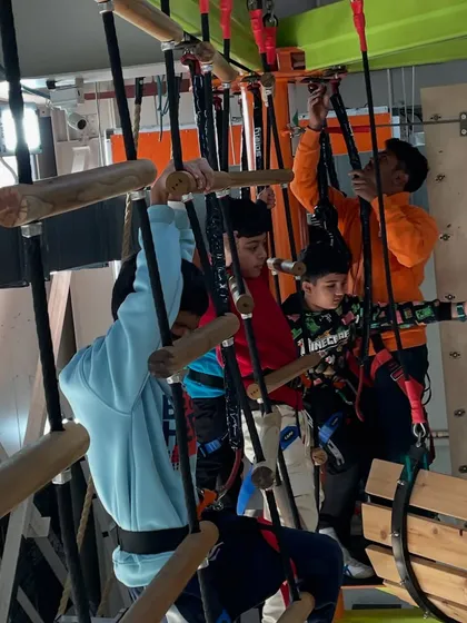 Teamwork makes the dream work, even on the Sky Maze. Friends navigate the obstacles together, making for a memorable birthday group activity.
