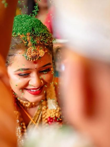 A duplicate of 78, a joyful close up of the bride during the Talambralu ritual.