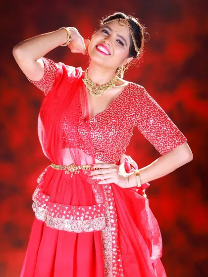 A fun and energetic pose from our red lehenga shoot. This kind of shot adds personality and life to a fashion portfolio.