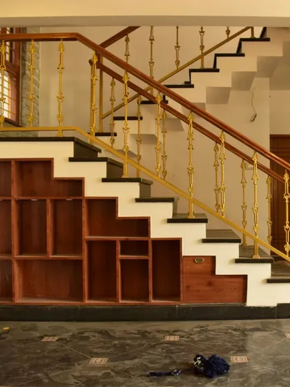A clever use of space, with custom wooden shelving built into the area beneath a staircase.