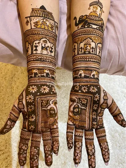 An engagement bride's mehndi telling a story. This design includes warli art depicting village life, a groom on an elephant, and a bride in a doli, creating a unique narrative.