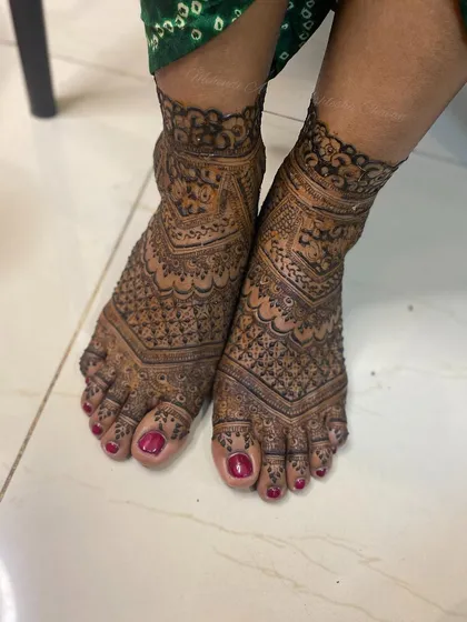 A full-coverage bridal feet design with intricate patterns. The design is dense and beautiful, perfect for a bride who wants a traditional look.